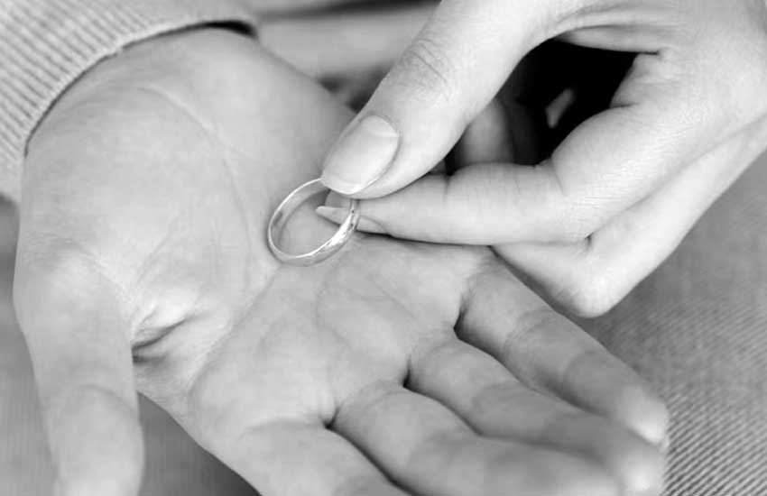 A hand with an engraved memorial ring