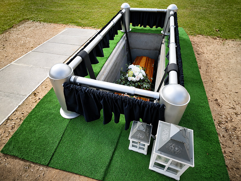 Cemetry lowering device